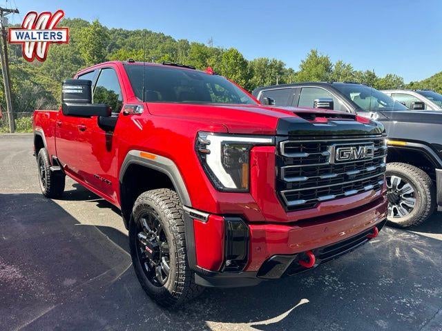 2026 GMC Sierra 2500 HD AT4 in Volcanic Red Tintcoat — front three-quarter view